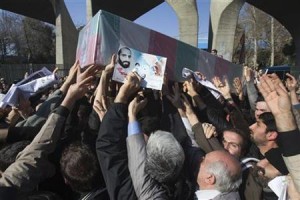 Iranian worshippers carry a picture and coffin of Mostafa Ahmadi-Roshan during his funeral after Friday prayers in Tehran