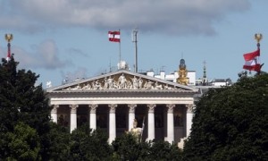 Austrian national flags are seen above the parliament house in Vienna