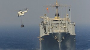 A US Naval vessel and helicopter in the Persian Gulf