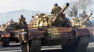 Iranin tanks run in a military parade.
