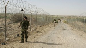 Iraqi soldiers stand guard along the Iraqi-Syrian border.