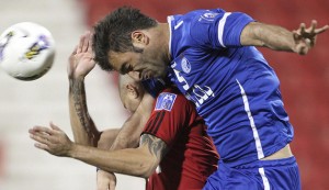Qatar's Al-Rayyan player Martins fights for the ball with Iran's Al-Esteghlal player Zadeh during their AFC Champions League soccer match in Doha