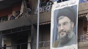 The picture of Lebanon's Hezbollah leader Sayyed Hassan Nasrallah hangs from balcony at site of Tuesday's explosion in the Haret Hreik area in Beirut