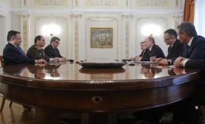 Russian President Putin speaks with Egyptian FM Fahmy and Army chief Field Marshal Abdel Fattah al-Sisi during their meeting at Novo-Ogaryovo