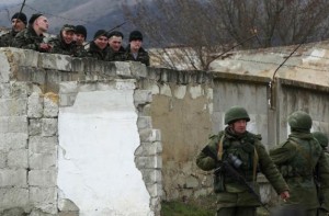 Ukrainian servicemen talk to armed men, believed to be Russian servicemen