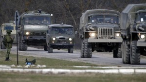 Military vehicles drive near a Ukrainian military base in the village of Perevalnoye