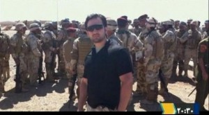 Iranian-American Amir Mirza Hekmati, who has been sentenced to death by Iran's Revolutionary Court on the charge of spying for the CIA, stands with Iraqi soldiers in this undated still image taken from video in an undisclosed location