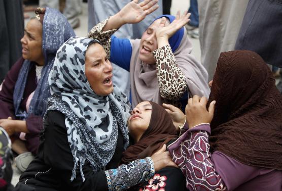 Relatives and families of members of Muslim Brotherhood and supporters of ousted President Mursi react after hearing the sentence, in front of the court in Minya, south of Cairo