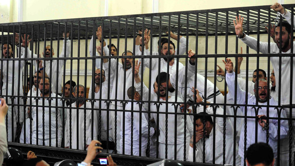 Supporters of former Egyptian president Mursi, standing trial on charges of violence, react after two fellow supporters were sentenced to death, in a court in Alexandria