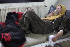 A woman breathes through an oxygen mask inside a field hospital in Kfar Zeita village in the central province of Hama