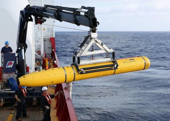 Handout of crew aboard the Australian Defence Vessel Ocean Shield moving the U.S. Navy's Bluefin-21 into position for deployment, in the southern Indian Ocean to look for the missing Malaysia Airlines flight MH370