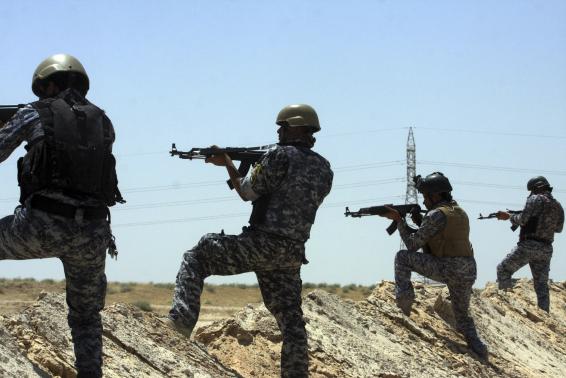 Members of the Iraqi security forces patrol an area near the borders between Karbala Province and Anbar Province, June 16, 2014 file photo. REUTERS/Mushtaq Muhammed