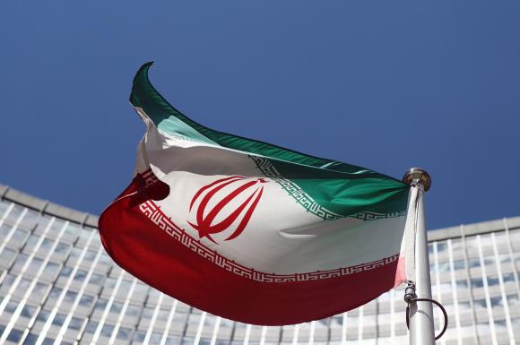 An Iranian flag flutters in front of the UN headquarters in Vienna
