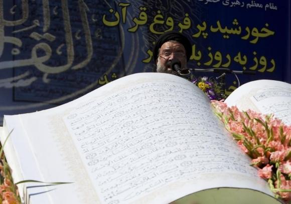 Ayatollah Ahmad Khatami gives a speech in front of a large model of the Koran during a demonstration after Friday prayers in Tehran