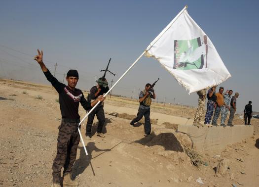 Iraqi Shiite militia fighters celebrate after breaking a long siege of Amerli by Islamic State militants