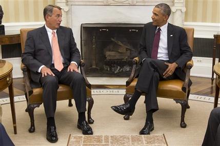 President Barack Obama talks with House Speaker John Boehner of Ohio in the Oval Office of the White House in Washington, Tuesday, Sept. 9, 2014. The president met with Congressional leaders to discuss options for combating the Islamic State. (AP Photo/Evan Vucci)