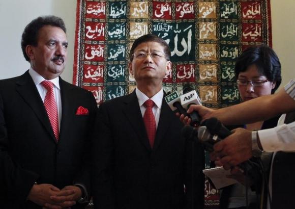 Chinese Public Security Minister Meng speaks to reporters as Pakistan's Interior Minister Malik looks on, after arriving at a military base in Rawalpindi