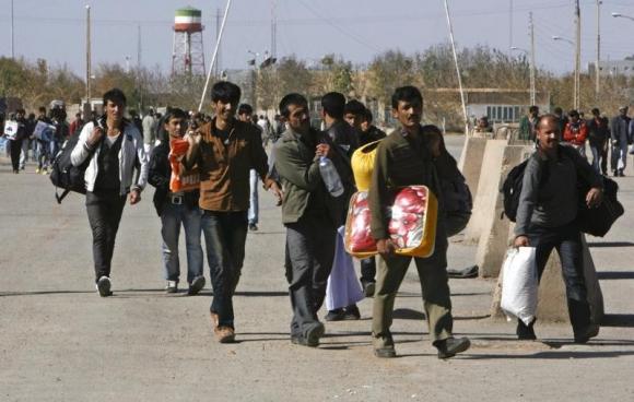 Group of Afghan migrant workers enter Afghan territory after leaving Iran at the Islam Qala border in Herat province