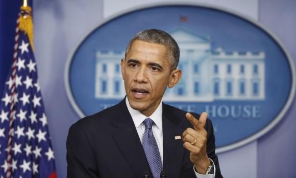 U.S. President Barack Obama answers a question after his end of the year press conference in the briefing room of the White House in Washington, December 19, 2014. CREDIT: REUTERS/LARRY DOWNING