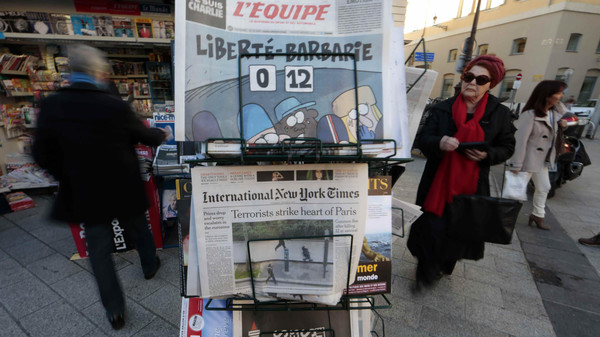 The front pages of daily papers are displayed in a newspaper kiosk in Nice the day after a shooting at the Paris offices of Charlie Hebdo
