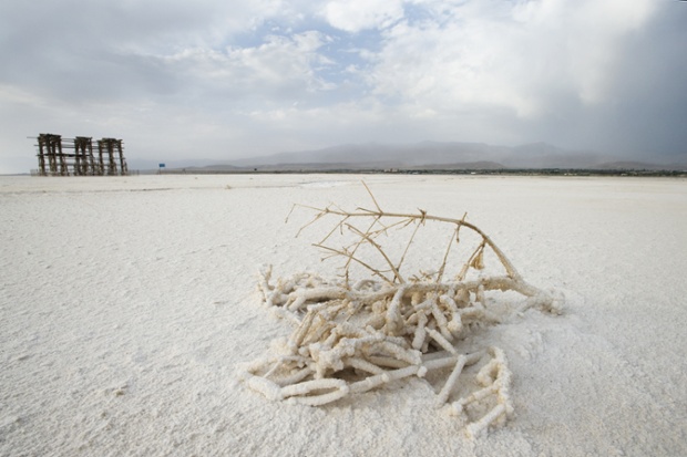 08 Aug 2010, Iran --- Water has left the path to salt drifts, dry shrubs and abandoned piers. Lake Urmia, Iran. -- The third largest salt water lake in the world is drying up fast, as experts fear another environmental disaster in the Aral Sea. Lake Urmia, Iran. July 2011. --- Image by Alessandro Marongiu / Demotix/Demotix/Corbis