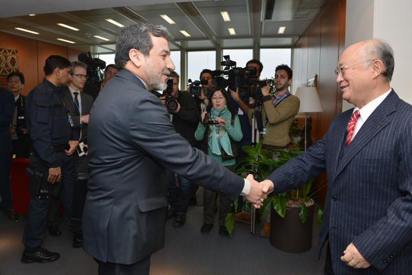 The member of Iran's nuclear negotiating team shakes hands with Amano on Feb 24, 2015.