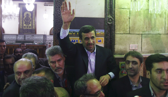 Iran's President Mahmoud Ahmadinejad (C) waves near the shrine (L) of Prophet Muhammad's grandson Hussein ibn Ali at the Al-Hussein Mosque, named after the grandson, in the old part of Cairo, Feb. 5, 2013. (photo by REUTERS/Amr Abdallah Dalsh)
