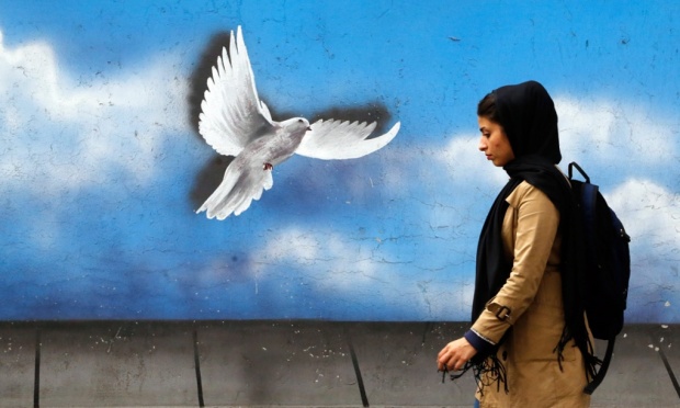 An Iranian woman walks down a street in Tehran, Iran. Abedin Taherkenareh/EPA Photograph: Abedin Taherkenareh/EPA