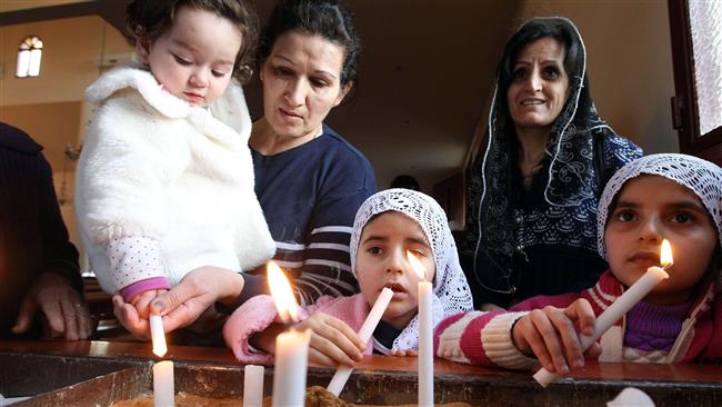 Assyrian Christian women and their daughters, who had fled the unrest in Syria, attend a prayer for 220 Assyrian Christians abducted by ISIL militants from villages in northeastern Syria in recent days, at the Saint Georges Assyrian Church in Jdeideh, northeast of the Lebanese capital Beirut on February 26, 2015 (AFP photo).