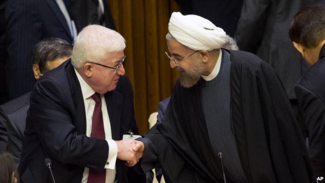 Iraq's President Fuad Masum, left, is greeted by Iranian President Hassan Rouhani as he arrives at the Climate Summit 2014 at U.N. headquarters, Sept. 23, 2014.