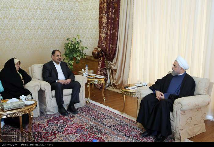 Iran's president Rouhani meets newly-released Iranian diplomat Noor Ahmad Nikbakht who was kidnapped by terrorists in Yemen on March 14, 2015.