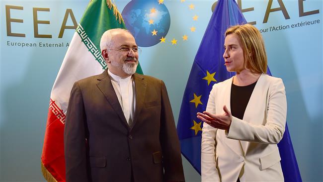 Iranian Foreign Minister Mohammad Javad Zarif (L) is welcomed by EU foreign policy chief Federica Mogherini on March 16, 2015 at the European External Action service headquarters in Brussels. AFP