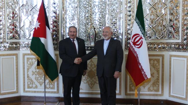 Iranian Foreign Minister Mohammad Javad Zarif (R) shakes hands with his Jordanian counterpart Nasser Judeh in the Iranian capital, Tehran, on March 7, 2015.