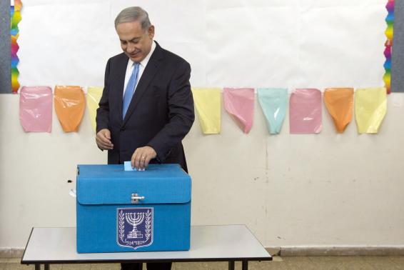 Israel's Prime Minister Benjamin Netanyahu casts his ballot for the parliamentary election at a polling station in Jerusalem March 17, 2015.