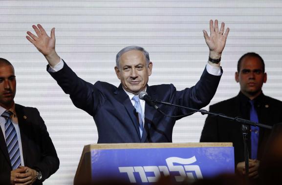 Israeli Prime Minister Benjamin Netanyahu waves to supporters at the party headquarters in Tel Aviv March 18, 2015.