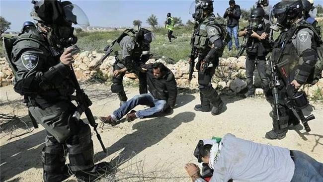 Israeli soldiers attack Palestinian activists protesting against construction of the separation wall in the occupied West Bank. (File photo)